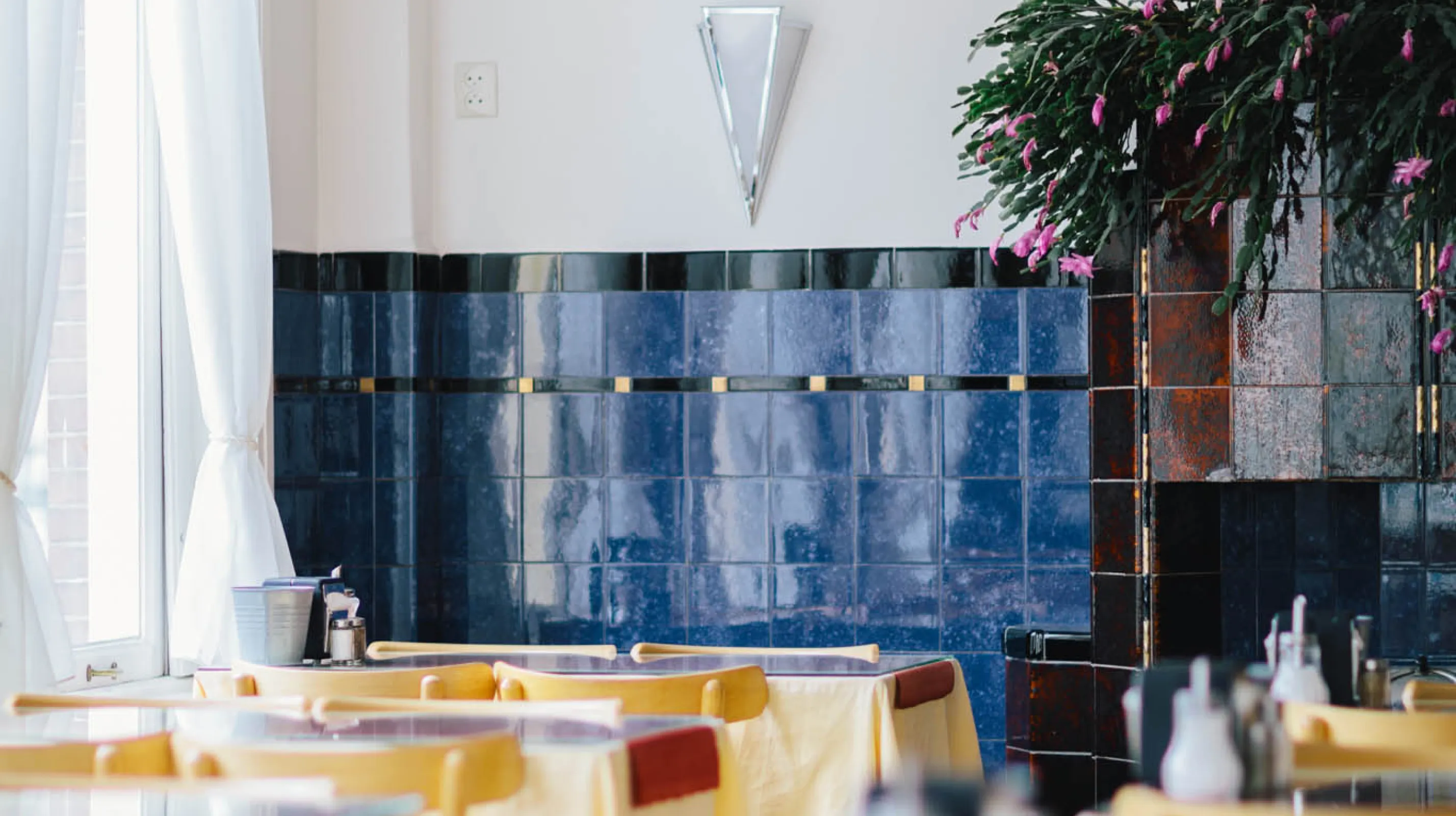 The restaurant with its historic blue tiles and laid tables by the windows